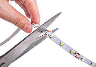 A person cutting a LED strip light