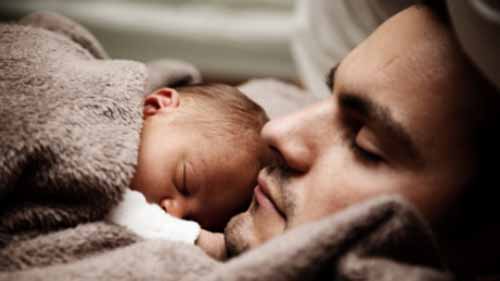 A man and baby sleeping