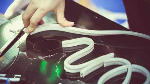 A person making a custom LED neon sign