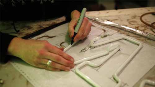 A technician designing a neon sign